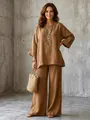 Macro view of brown cotton linen two-piece set featuring relaxed shirt and wide-leg pants - Caramel color