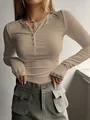 Detailed shot of women's beige ribbed long sleeve henley top featuring button details - Khaki