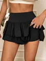 Close-up detail showing the texture of black high-waisted tiered skort with built-in shorts - S / Bottoms / Black