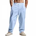 Front detail view of light blue loose linen trousers for men featuring drawstring waist - Light Blue