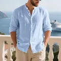 Detail view of men's light blue stand-collar linen Henley shirt in a coastal setting - S / Tops / Light Blue