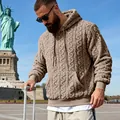 Close-up of men's brown cable-knit teddy fleece hoodie in an outdoor travel setting. - S / Tops / Camel