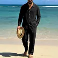Detailed view of a man wearing a black long-sleeve linen shirt and matching pants on a beach - S / Top And Bottom / Black