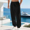 Detailed view of men's black linen joggers with drawstring waist in beach setting - S / Bottoms / Black