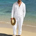 Close-up of a man wearing a white linen hooded shirt and trousers set on a sunny beach - S / Top And Bottom / White