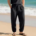 Breathable men's black cotton linen joggers styled in a relaxing summer beach setting - S / Bottoms / Black