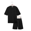Black checkered two-piece men's set with t-shirt and shorts hanging on wooden hangers - S / Top And Bottom / Black