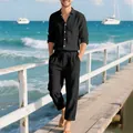 Detailed view of a man wearing a black linen shirt and pants set on a seaside pier. - S / Top And Bottom / Black