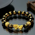Close-up of feng shui Pixiu bracelet with gold mantra symbols on black obsidian beads - Golden Beads PiXiu Mantra Bracelet / 12mm