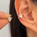 Elegant gold plated pear-shaped zircon ear cuff for non-pierced ears shown being worn - 1 Pair (Left and Right) / Gold
