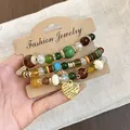Handmade retro ethnic beaded bracelet set featuring wood and glass beads on display card - Three-Piece Set / Gold-Yellow-Green