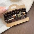 Vintage beaded bracelet set with wood beads and butterfly charm on display card. - Butterfly / Four-Piece Set / Brown