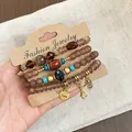 Vintage ethnic style four-piece beaded bracelet set with heart, owl, and Eiffel Tower charms. - Owl / Four-Piece Set / Gold-Light Coffee