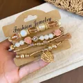 Boho chic beaded bracelet set featuring pearls, roses, tassels, and leaf charms - Four-Piece Set / Gold-Pink