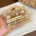 Handmade bohemian beaded bracelet set featuring cream beads and golden accents for women - Four-Piece Set / Gold-Khaki