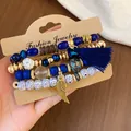 Bohemian multi-layered beaded bracelet set with navy blue tassel and gold wing charm - Feather / Four-Piece Set / Gold-Dark Blue