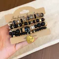 Retro ethnic style multi-layer beaded bracelet set featuring an engraved gold heart charm - Heart / Four-Piece Set / Gold-Black