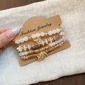 Retro ethnic style white beaded bracelet set with golden leaf charms on display card - Leaf / Four-Piece Set / Gold-Beige