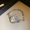 Detailed shot of an elegant heart-shaped rhinestone watch with silver adjustable chain strap - Heart-shaped Dial / Silver