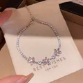 Elegant pink flower zircon tennis bracelet displayed on a beige canvas gift pouch - Pink Zirconia Flower Cluster (8#)