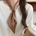 Elegant brown paisley print silk scarf necklace featuring a vintage decorative button clasp - Light Brown Paisley