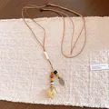 Detailed macro view of a leather cord necklace with beads and an everlasting rose pendant - Yellow