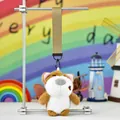 Detailed view of cute plush dog keychain with khaki lanyard hanging on display stand - Big Nose Dog - Short Ear White Brown (Colored Strap)