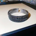 Vue détaillée d'un élégant bracelet jonc multicouche en strass noirs pour femmes - Style 66 Jonc (Ouvert Trois Rangs Tout Strass)
