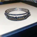 Gros plan d'un bracelet jonc multi-rangs en diamants noirs avec motif losange - Style 64 Jonc (Ouvert Trois Rangs Losange Noir)