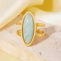 Close-up detail of 18K gold plated stainless steel ring with large oval blue marble stone - Light Blue Marble Pattern Oval Ring (A710 Gold White Oval Ring) / One Size (A710) / Gold