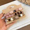 Bohemian style beaded bracelet set with rhinestones and glass beads on display card. - Four-Piece Set / Gold Brown