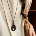 Close-up of vintage brown wooden ring necklace with artistic pendant on beige linen dress. - Nested Black Matte Style (77#) / Coffee/Black