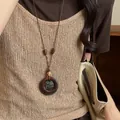 Retro brown wood ring necklace in old money style shown as a detailed view on a model. - Double Layer Geometric Round Style (75#) / Coffee