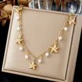 Detailed macro view of gold starfish pendants and white pearls on a stainless steel chain - Gold 3D Sea Star Artificial Pearl Choker (N4573)