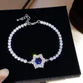 Exquisite silver-toned tennis bracelet featuring a stunning blue zircon snowflake centerpiece - Blue