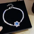 Elegantes Zirkonia-Armband mit Schneeflocken-Design und blauem Stein in Silber - Himmelblau