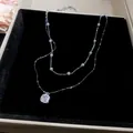 Detailansicht einer französischen Doppel-Halskette mit Perlen und quadratischem Diamant. - 24# Halskette Doppelter Quadratischer Zirkonia Perle