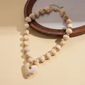 Vintage style beige marbled acrylic beaded necklace featuring a large heart pendant - Necklace / White