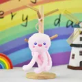 Detail view of a cute pink plush jellyfish keychain featuring blue eyes and heart mouth - Octopus Shape / Pink / Height 14cm
