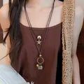 Close-up of bohemian double-layer necklace with star pendant and ethnic charms - Woven Basket and Star Style (47#) / Brown/Gold