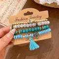 Close-up of Bohemian 4-piece beaded bracelet set with Hamsa hand and blue tassel - Bracelet Style / Four-Piece Set / Blue