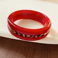 Close-up detail of a bright red resin bangle with a stylish leopard print strap center - Full Synthetic Leather Style / Red