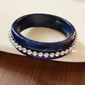 Macro detail showing a minimalist navy blue resin bangle with embedded silver beads - Metal Beads / Blue