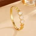 Detailed close-up view of a Bohemian gold titanium steel bangle with white stone inserts. - Gold White Rhinestone Style (G120) / Gold