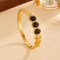 Macro view of bohemian gold PVD plated stainless steel bangle with black oval stones - Gold Black Rhinestone Style (G120) / Gold