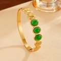 Close-up of bohemian gold PVD plated stainless steel bangle with green stone inlays - Gold Green Rhinestone Style (G120) / Gold