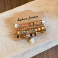 Detailed view of Bohemian-style bracelet set with acrylic beads and shell charms - Style 5