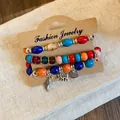 Close-up of Bohemian acrylic beaded bracelet set featuring wing and elephant charms - Style 9