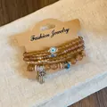 Detail view of Bohemian beaded bracelet set with Evil Eye and Hamsa hand charms. - Style 8