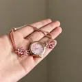 Close-up of elegant rose gold jewelry watch featuring pink crystal floral charms - Pink Radial Pattern Dial / Sliding Adjuster Buckle / Bracelet-Gold-Pink